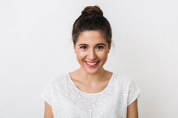 close-up portrait young pretty woman smiling in white t-shirt on white background, happy, positive mood, isolated, sincere smile