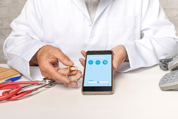 Audiologist showing smartphone application to make adjustments. Manage hearing aid settings via...