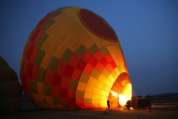 Preparing hot air balloon for flight at night, Rajasthan, India
