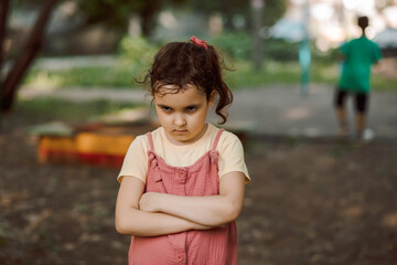 Upset lonely bullied little kid girl looking away feels abandoned abused, sad alone preschool child...