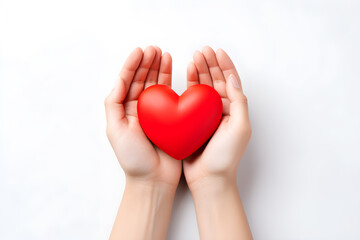 Obraz premium Aerial view of red plastic heart shape on two hands isolated on white background.