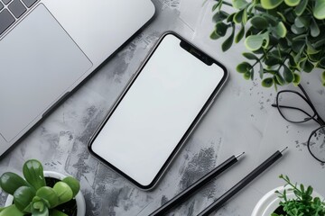 Top view of white office table with laptop, smartphone and supplies. Top view with blank screen, copy space
