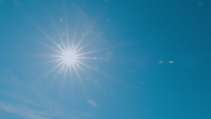 Bright Shining Sun In A Blue Sky No Clouds. Sunbeams And Flares Shining On Sunny Clear Blue Sky Background In Tropical Summer. Sunny Day.