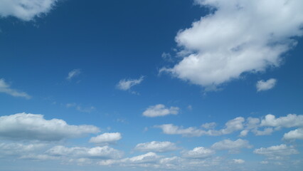 Obraz premium Blue sky soft silky stratocumulus clouds. Background of sky and clouds. cumulus clouds in clear bright summer day. Timelapse.