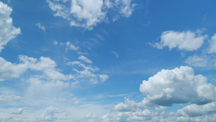 Soft white clouds moving on blue sky background. Tropical summer or spring sunlight. Daytime....