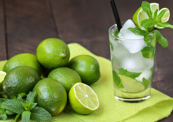 Mojito with ice in a glass and fresh lime