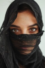 Naklejka premium Close-up view of a person's face with a veil covering their identity, suitable for use in scenarios where anonymity is desired