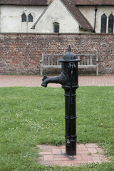 old water pump in front of St James Church in the village of Southwick Hampshire England