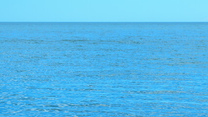 Background Of Summer Morning Look Calm With Deep Blue Water. Seascape View With Blue Sky.