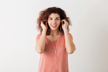 portrait of young natural looking smiling happy hipster pretty woman in pink shirt