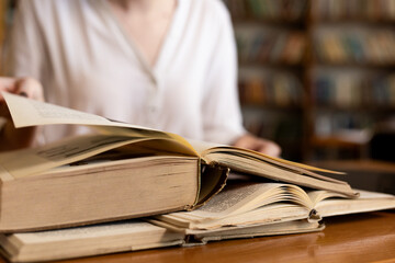 close-up of a young girl student holding a book in her hands, showcasing her passion for...