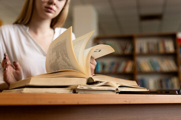 close-up of a young girl student holding a book in her hands, showcasing her passion for...