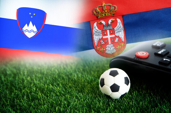 football match , Slovenia vs Serbia , Football Nation Flag and soccer ball on green grass