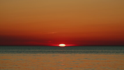 Sea With Sun Light In Background At Sunset. Orange And Red Sunset Over Sea. Fantastic Natural Sunset. Slow motion.