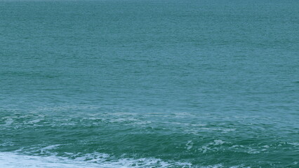 Turquoise Ocean Boiling With Foamy Waves. Sea Waves Crashing. Real time.