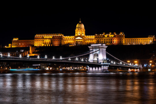 The historical Buda castle district above the Danube river illuminated by lights at night in Budapest	