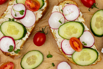 Sandwiches with vegetables and soft cheese pattern top view