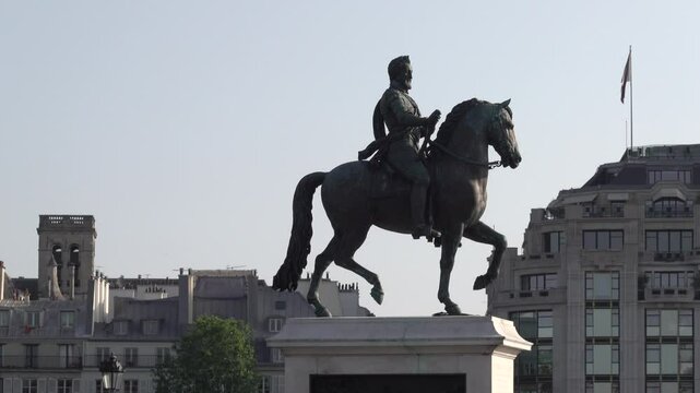 Equestrian statue of Henry IV, against blue sky on Pont Neuf bridge on a sunny day in Paris, France