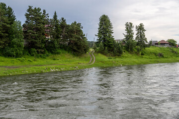 summer panoramic landscape of mountains and forests and lakes against the sky in the area of ​​Lake Teletskoye in Altai