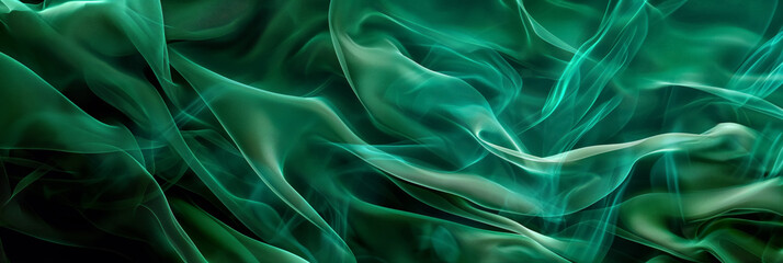 Obraz premium Abstract green smoke-like fabric swirling dynamically against a black background, creating a sense of movement and mystery.
