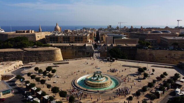 Aerial drone view of Valletta - capital of Malta island Europe, Mediterranean sea main church, dome, view of the Triton Fountain in the city center