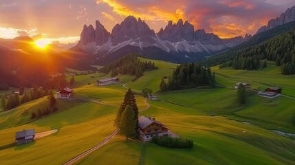 An aerial view of the Dolomites in Cortina d'Ampezzo at sunset, showcasing five towering peaks, lush green valleys, and scattered rustic houses.