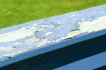 Peeling blue paint on outdoor railing