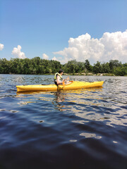 A young guy is kayaking on the river. Sports and an active lifestyle