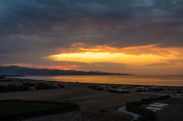 Full frame of the low angle view of sky and clouds of yellow and orange color and the in the sunset.