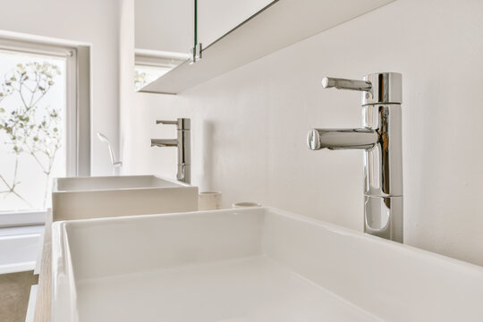 Modern minimalist bathroom sink and chrome faucets