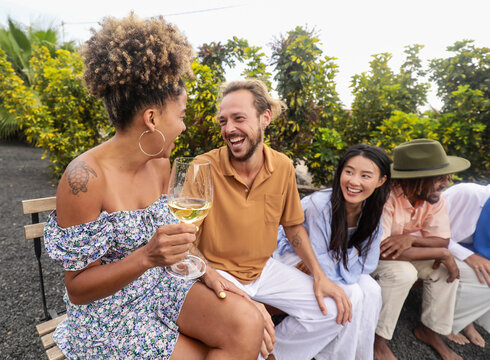 Friends enjoying conversation and wine outdoors