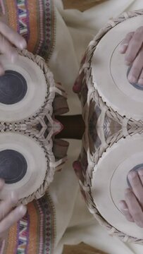 hands on tabla drum in vertical