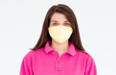 Coronavirus, masked woman.Studio portrait of a young woman wearing a face mask, looking at camera, on white background.