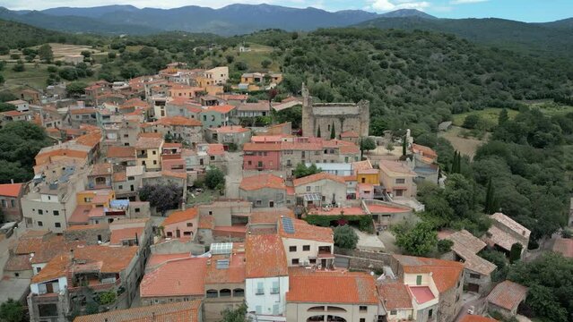 Aerial drone images of Rabos, a small medieval town in the mountains of Catalonia in Spain, surrounded by green vineyards