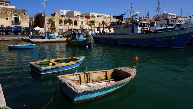 Marsaxlokk harbour with Traditional Luzzu fishing boats, a beautiful Mediterranean town on a sunny day. Old Colorful Boats. Malta 
