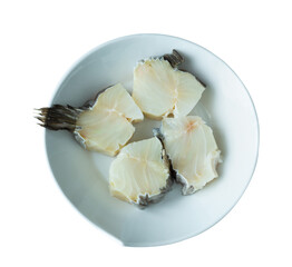 Four pieces of raw cod on a white plate with isolated background.