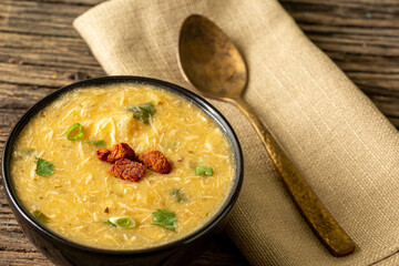 Caldo de Kenga Cassava broth with shredded chicken, typical Brazilian food known as (Caldo de...