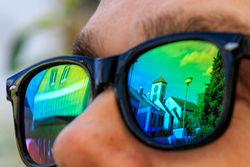 The steeple of St Albert's Church in Augsburg is reflected in the lenses of a pair of sunglasses