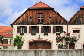 Weißenkirchen, Lower Austria. A traditional Austrian chalet with rambling roses and wooden shutters on the window against a bright blue sky