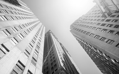 Looking up at New York City skyscrapers against the sun, USA.