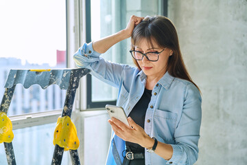 Female decorator of final finishing, repair manager in new apartment office