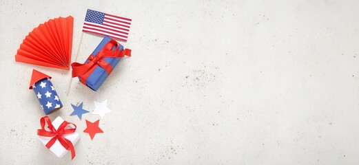 Obraz premium Gift boxes, USA flag, firework rocket and fan on light background with space for text. American Independence Day