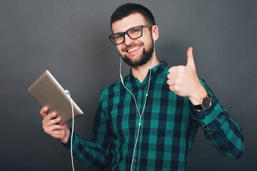 young handsome hipster bearded man on grey background