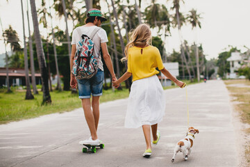 young stylish hipster couple in love on vacation with dog and skateboard