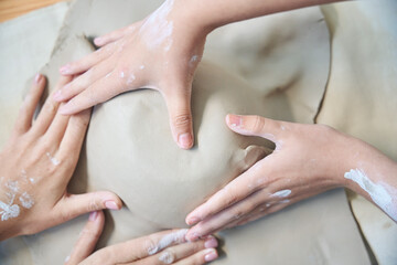 Professional ceramic artist making clay plate in modern pottery workshop