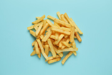 Golden french fries on blue background