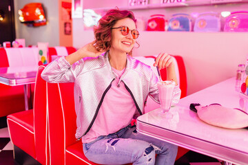 stylish smiling woman in retro vintage cafe