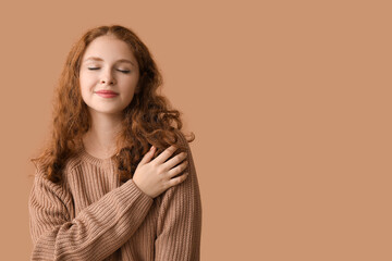 Portrait of relaxed young woman on brown background