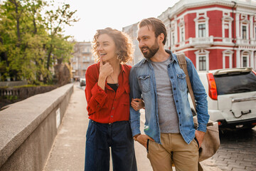 man and woman on romantic vacation walking together
