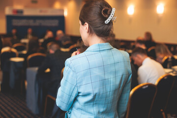 Audience at the modern conference hall listens to lecturer, people on a congress together listen to...